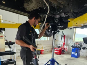 A Mechanic from GMK Mechanical doing engine repairs on a vehicle in Honey Brook, PA