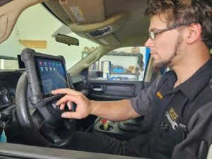 A mechanic from GMK Mechanical performing electric diagnostics on an engine in Lancaster, PA