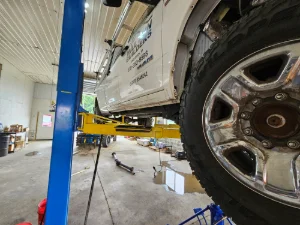 Large White Diesel Truck on a lift at GMK Mechanical in Quarryville, PA